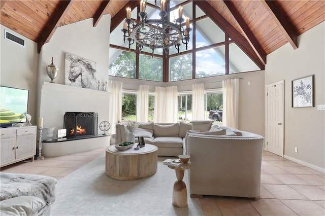 tiled living room with high vaulted ceiling, beam ceiling, a chandelier, and wooden ceiling