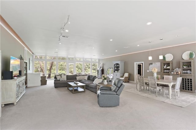 living room with light colored carpet, floor to ceiling windows, and track lighting