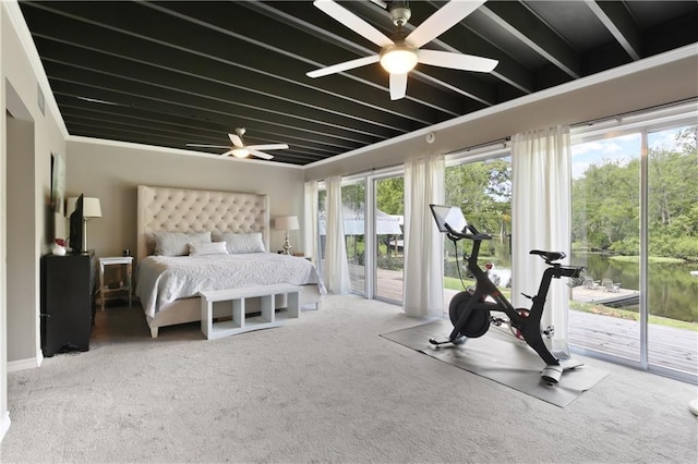 carpeted bedroom with ceiling fan, a water view, and access to outside