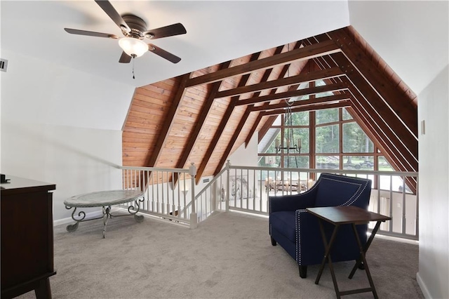 living area with ceiling fan, carpet flooring, vaulted ceiling with beams, and wooden ceiling