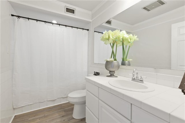 bathroom with toilet, crown molding, wood-type flooring, and vanity