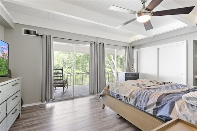 bedroom featuring ceiling fan, beam ceiling, wood-type flooring, and access to outside