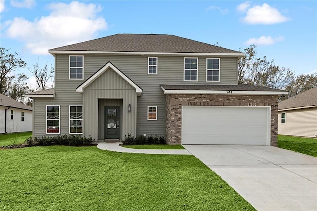 view of front of property with a front lawn and a garage