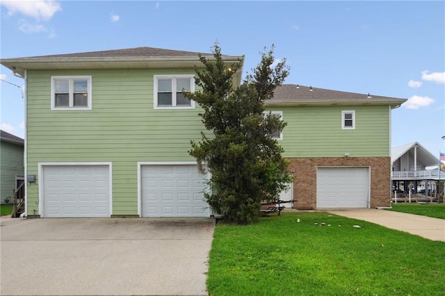 view of front of house with a garage and a front yard