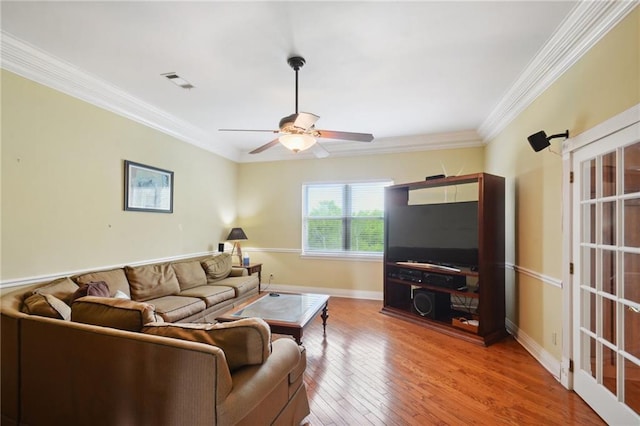 living room featuring hardwood / wood-style floors, ceiling fan, and ornamental molding