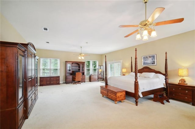 carpeted bedroom with ceiling fan and multiple windows