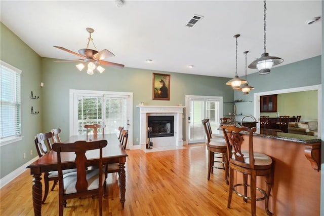 dining area with ceiling fan and light hardwood / wood-style flooring