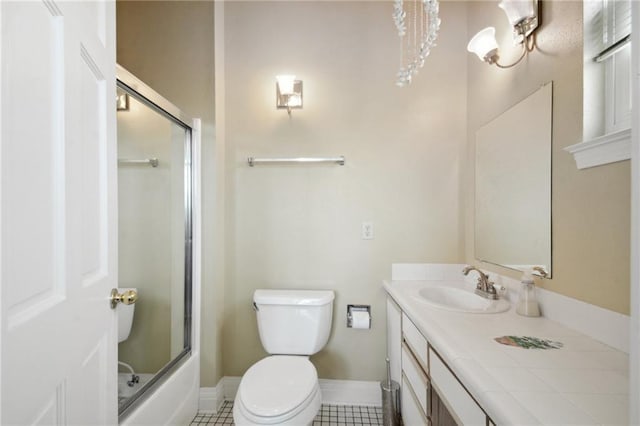 full bathroom with toilet, vanity, tile patterned floors, and bath / shower combo with glass door