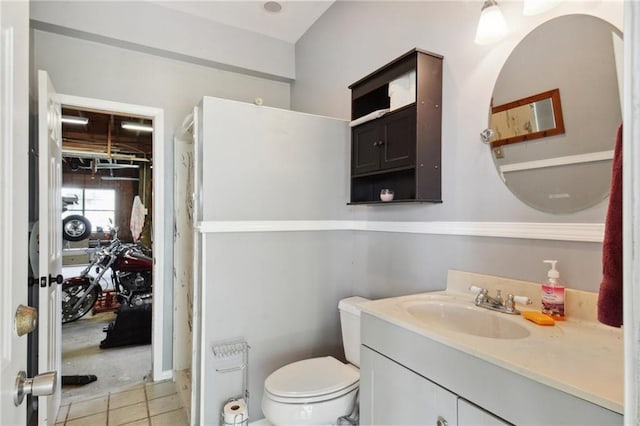 bathroom featuring tile patterned flooring, vanity, and toilet