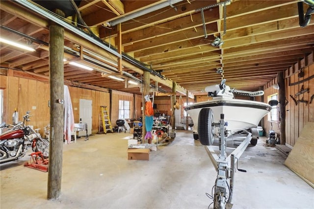 basement featuring wooden walls