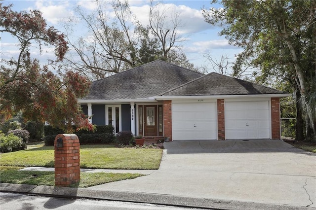 ranch-style home with a garage and a front yard