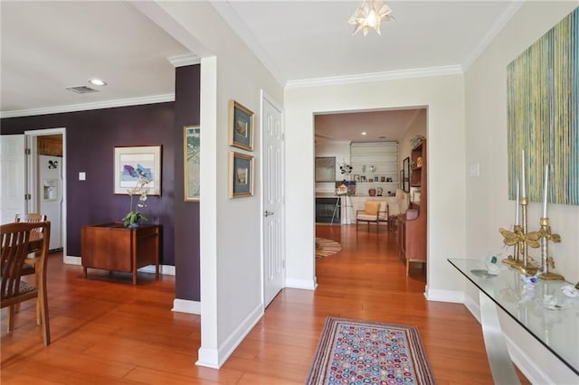 corridor with crown molding and wood-type flooring