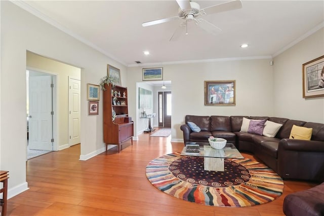 living room featuring ceiling fan, light hardwood / wood-style floors, and ornamental molding