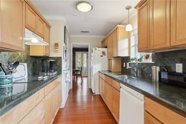 kitchen featuring tasteful backsplash, crown molding, pendant lighting, and white appliances