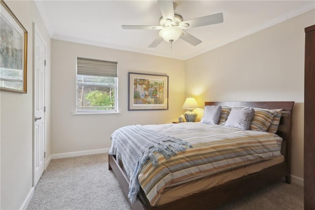 carpeted bedroom featuring ceiling fan and crown molding