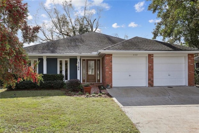 ranch-style house featuring a front yard and a garage