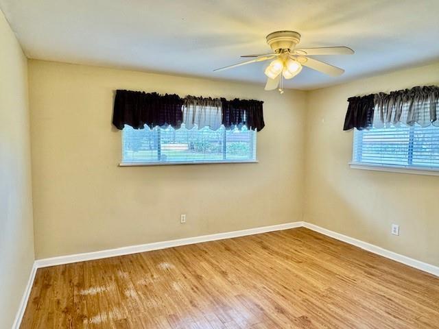 empty room featuring ceiling fan and hardwood / wood-style floors