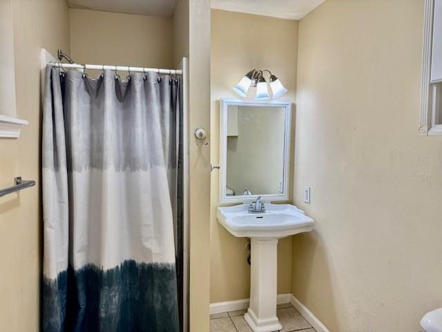 bathroom with tile patterned flooring and a shower with shower curtain