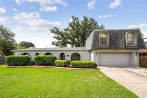 view of front of property featuring a garage and a front yard