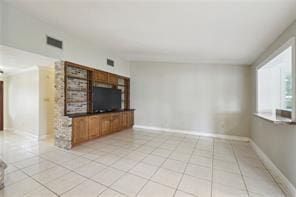 unfurnished living room featuring light tile patterned floors