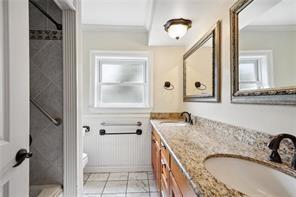 bathroom featuring ornamental molding, vanity, toilet, and tile patterned flooring