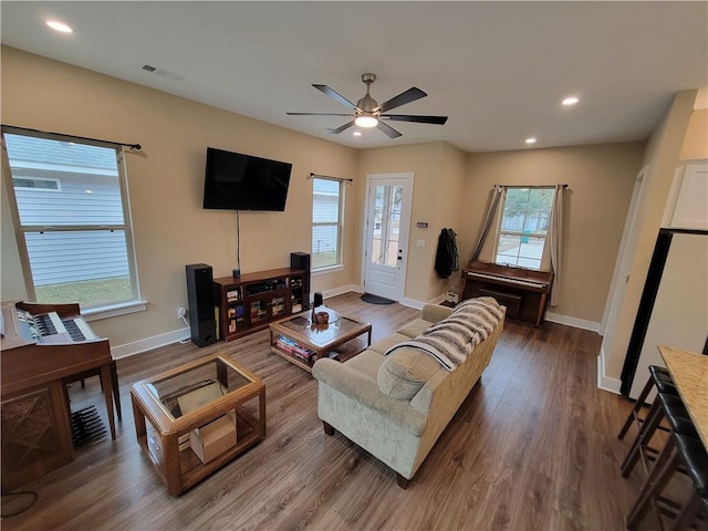 living room featuring hardwood / wood-style flooring, a wealth of natural light, and ceiling fan