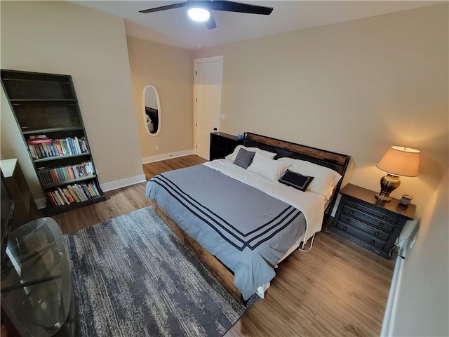 bedroom with ceiling fan and light hardwood / wood-style flooring