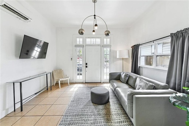 living room featuring a wealth of natural light, a wall mounted AC, and light tile patterned flooring