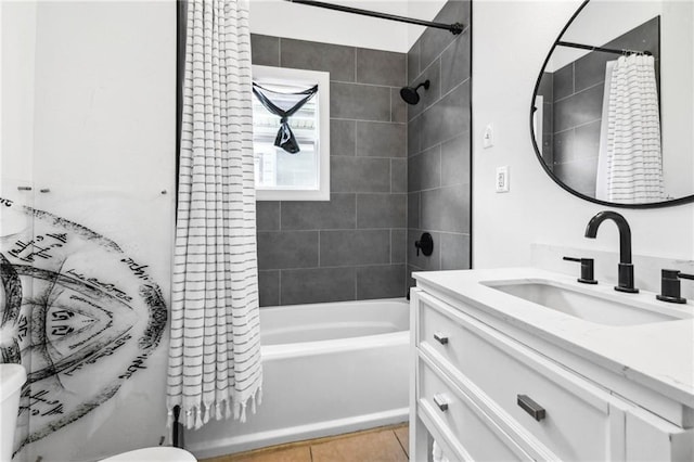 full bathroom featuring tile patterned floors, shower / bath combo with shower curtain, vanity, and toilet