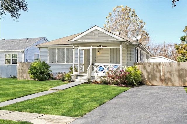 bungalow-style home with a porch and a front lawn