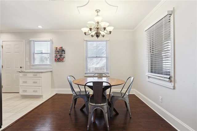 dining room featuring a notable chandelier, light tile patterned flooring, ornamental molding, and a wealth of natural light