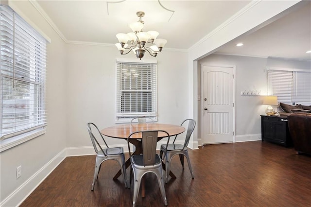 dining area with an inviting chandelier, crown molding, and dark hardwood / wood-style floors