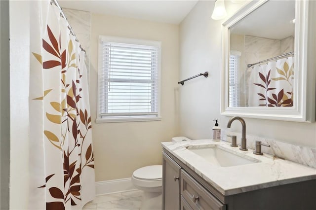 bathroom featuring toilet and vanity