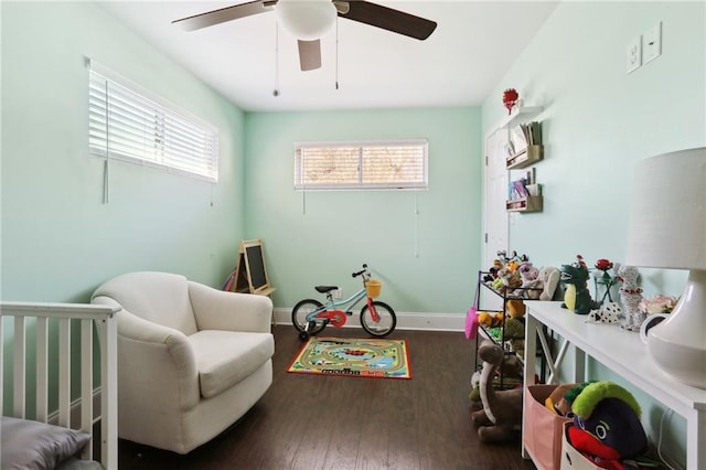 interior space featuring ceiling fan, a wealth of natural light, and dark hardwood / wood-style floors