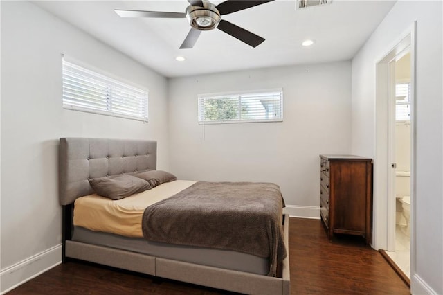 bedroom with ceiling fan, ensuite bath, and dark hardwood / wood-style floors