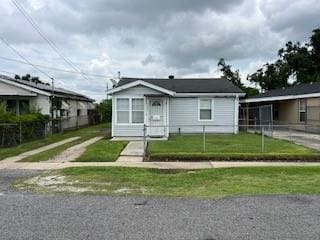 bungalow-style home featuring a front yard