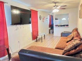 living room featuring tile patterned floors and ceiling fan