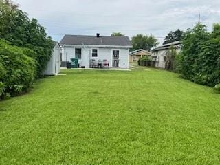 rear view of property featuring a yard