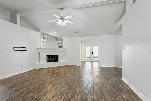 unfurnished living room with dark wood finished floors, beam ceiling, baseboards, and ceiling fan