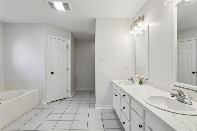 bathroom with double vanity, visible vents, tile patterned floors, and a sink