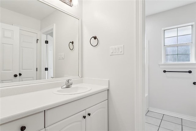 bathroom featuring tile patterned floors, vanity, and baseboards