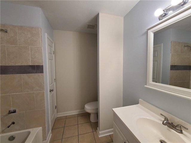 full bathroom featuring toilet, vanity, tiled shower / bath combo, and tile patterned floors