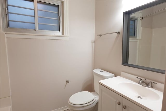 bathroom featuring toilet, walk in shower, and vanity