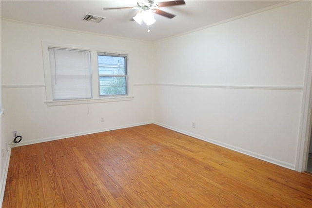 spare room featuring ceiling fan, ornamental molding, and hardwood / wood-style flooring