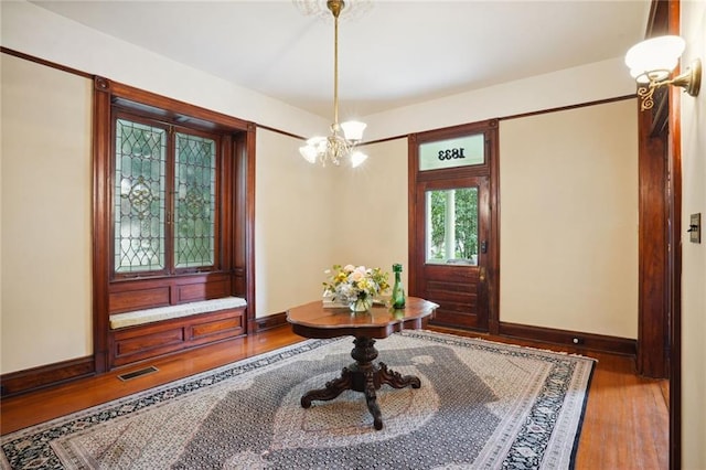 entryway featuring a notable chandelier and hardwood / wood-style flooring