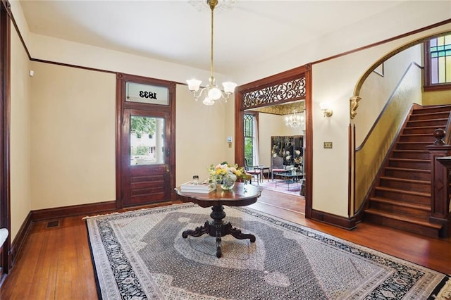 entrance foyer featuring hardwood / wood-style floors and a notable chandelier