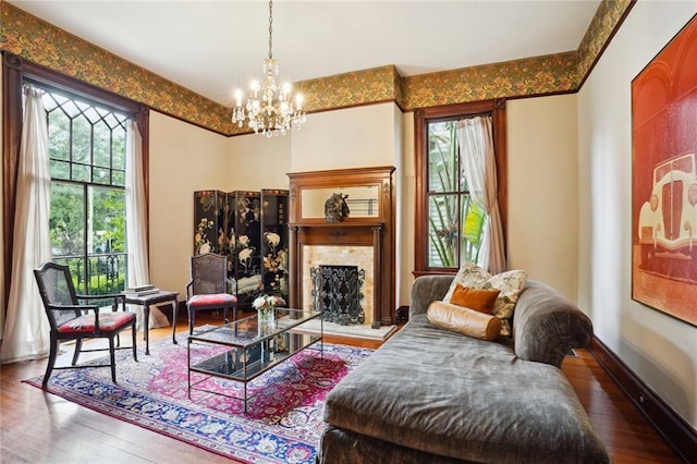 sitting room featuring wood-type flooring and an inviting chandelier