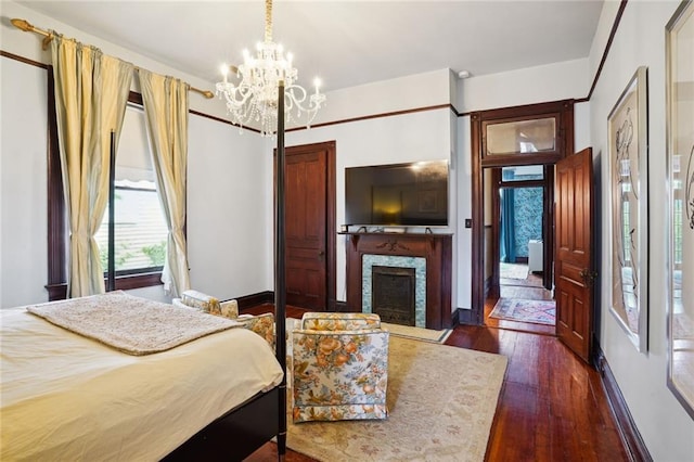 bedroom with dark hardwood / wood-style flooring and an inviting chandelier