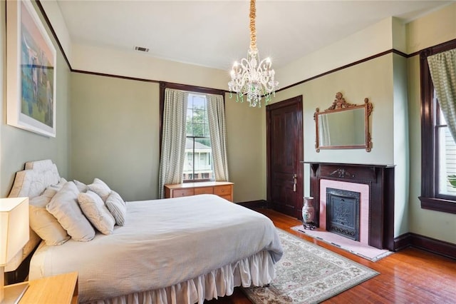 bedroom featuring light hardwood / wood-style flooring and a chandelier