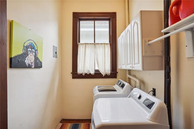 washroom with cabinets and washing machine and dryer